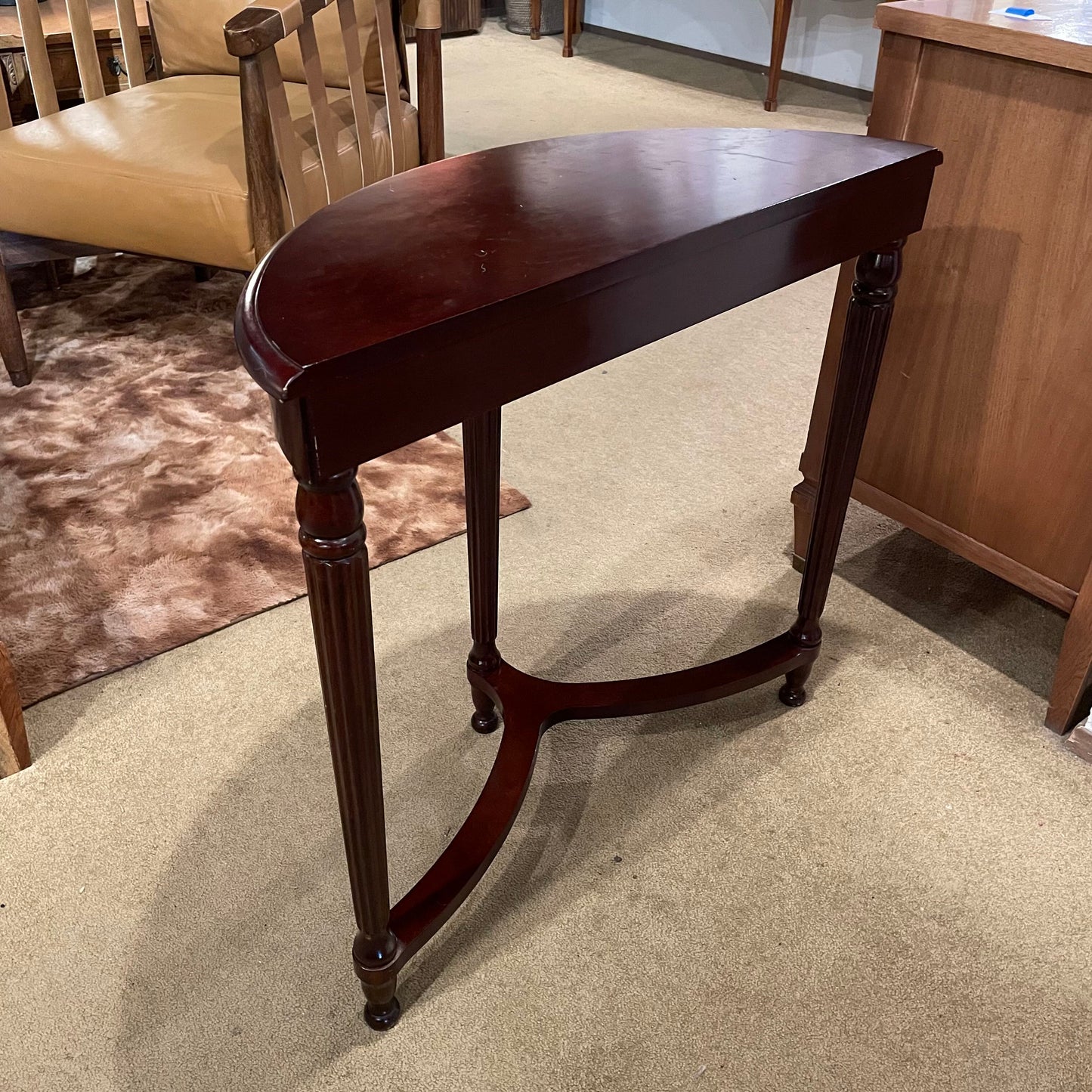 Wooden side table in a room with furniture and carpet