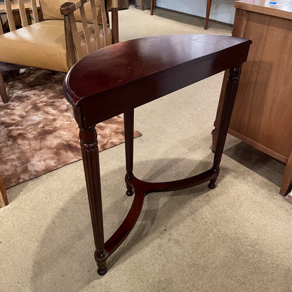 Wooden side table in a room with furniture and carpet