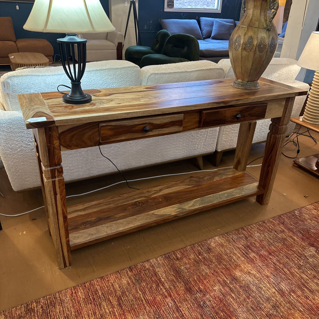 Wooden console table with a lamp and decorative item in a living room setting