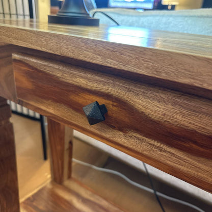 Wooden drawer with a black handle on a blurred background