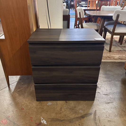 Dark wooden dresser in a room with tables and chairs