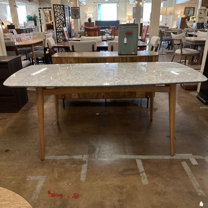 Dining table with marble-like surface in a showroom setting