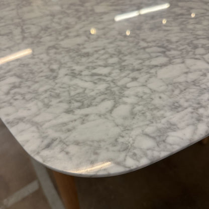 Close-up of a marble-patterned surface with wooden legs