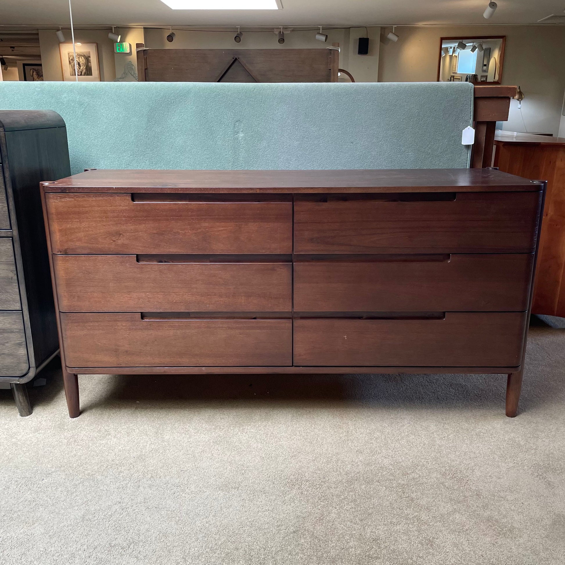 Wooden dresser with multiple drawers in a room setting