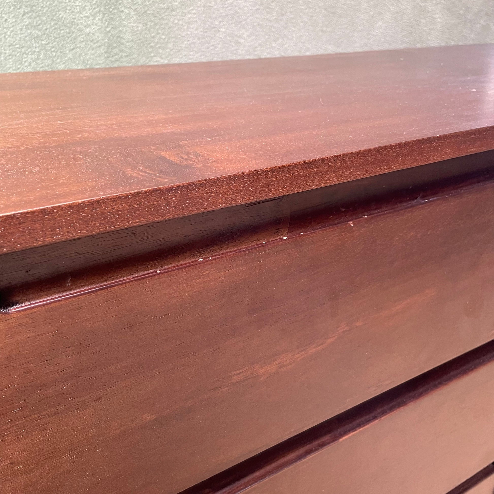 Close-up of a wooden surface with a visible brand name.