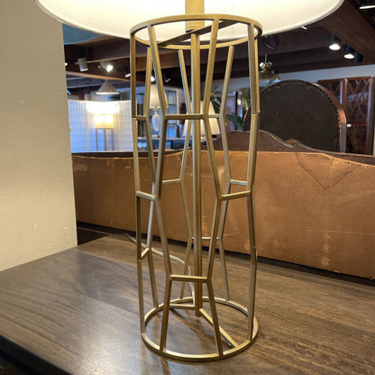 Gold metal bar stool in a room with a couch and lamp