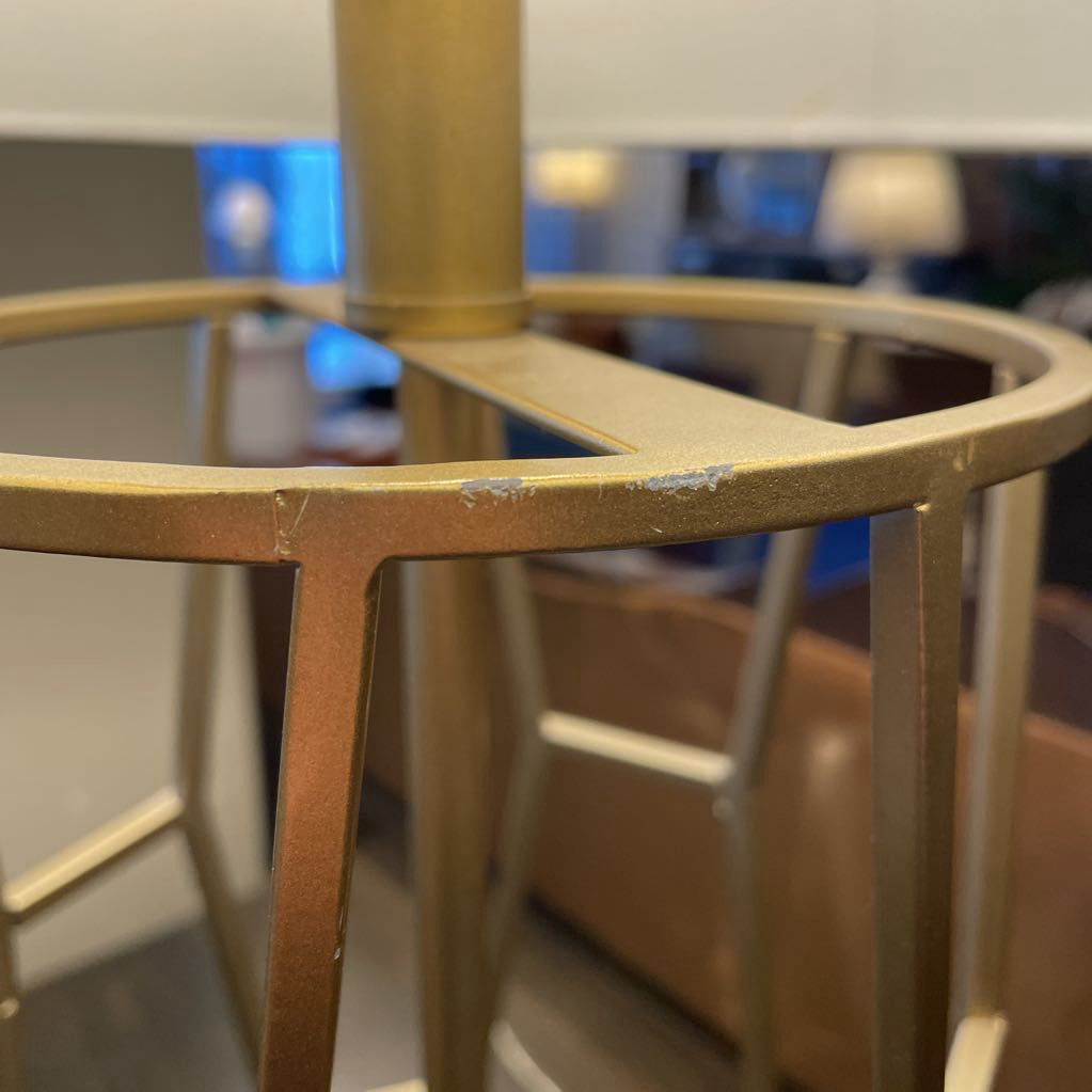 Gold metal frame with a blurred indoor background