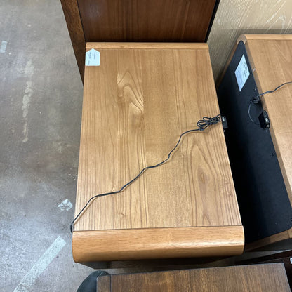 Wooden box with a black cable on a concrete floor