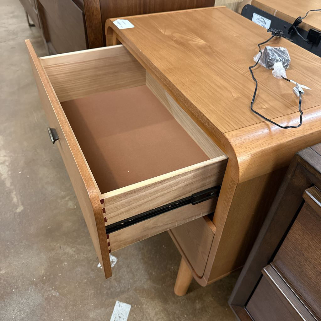 Wooden desk with an open drawer in a storage or warehouse setting