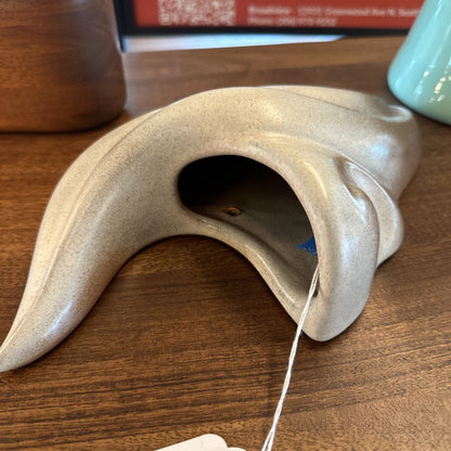 Tea bag holder on a wooden surface with a blurred background