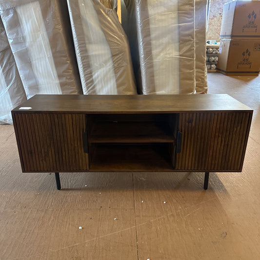 Wooden sideboard with plastic-wrapped items in the background