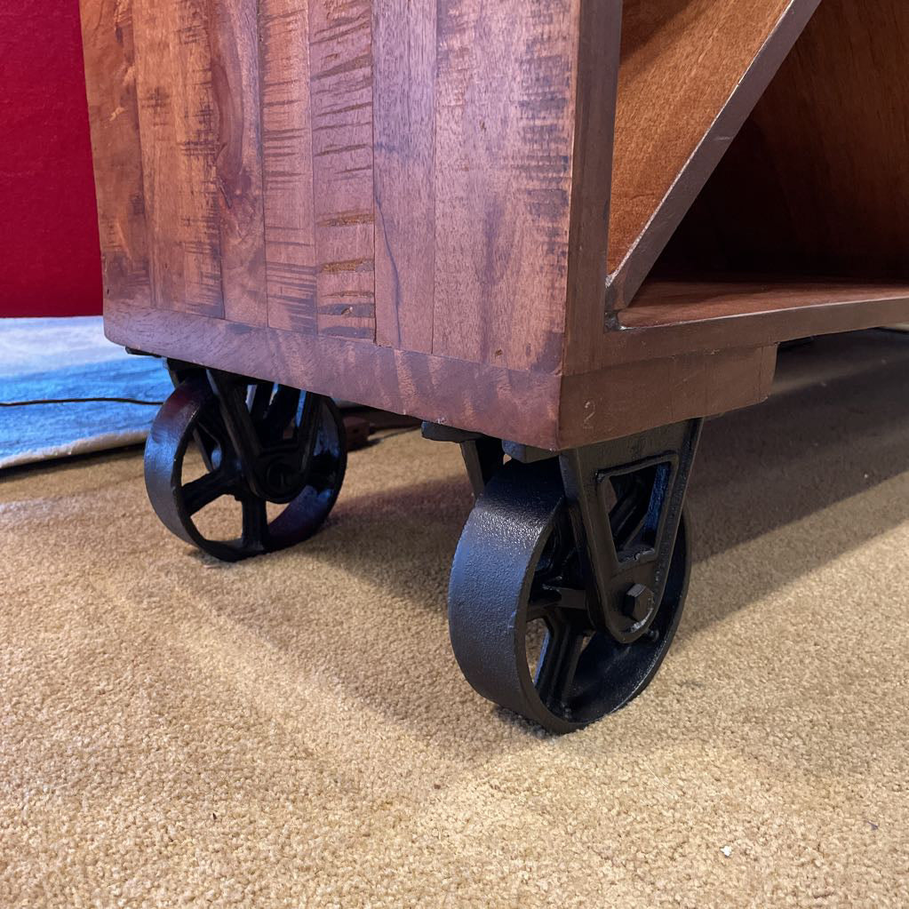 Wooden cart with wheels on a carpeted floor