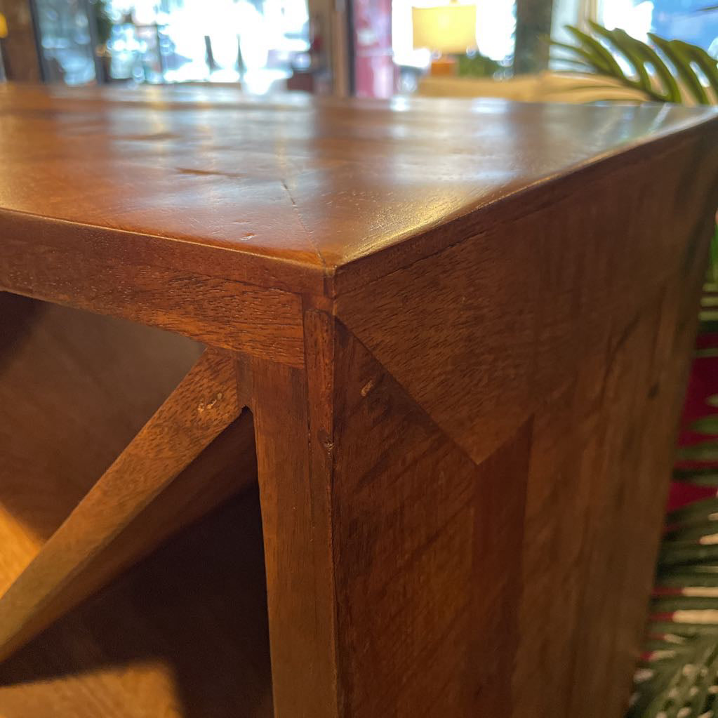 Close-up of a wooden table corner with blurred background
