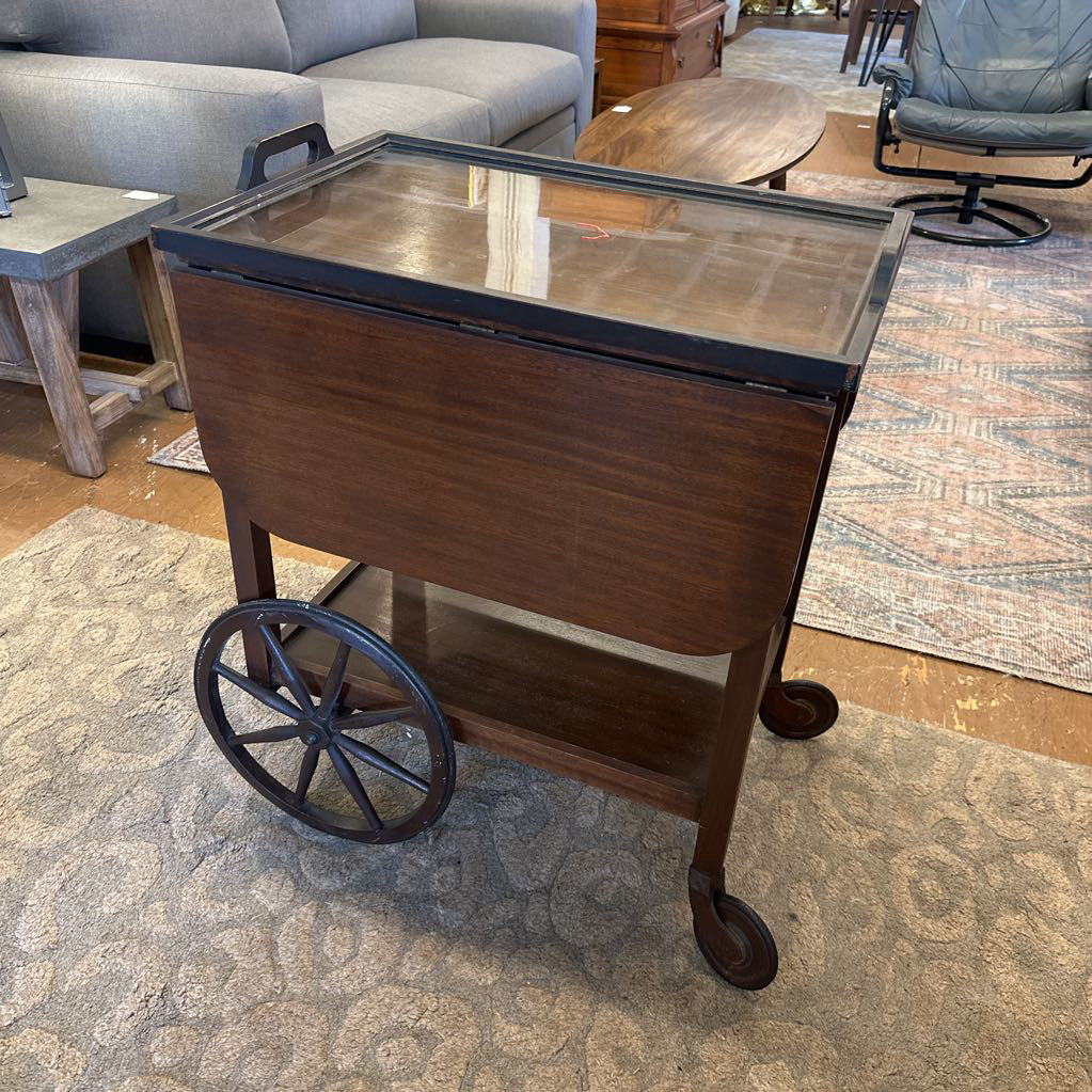 Wooden serving cart with a metal top in a room setting