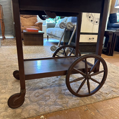 Wooden cart with wheels in a room with furniture and decor.