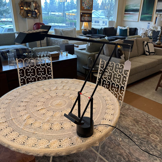 Round table with a decorative crochet cover in a living room setting