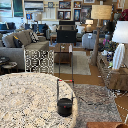 Living room with furniture and decor, including a coffee table and lamps.