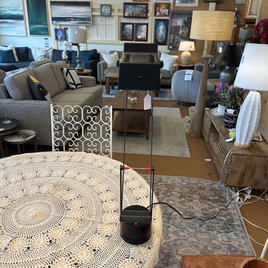 Living room with furniture and decor, including a coffee table and lamps.