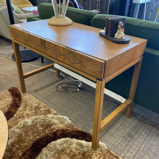 Wooden console table with decorative items in a living room setting