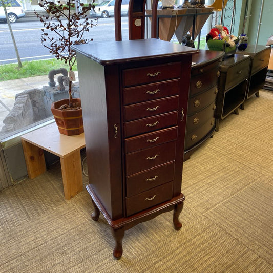 Wooden dresser with multiple drawers in a store setting