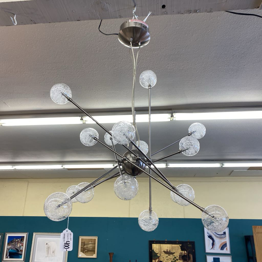 Modern chandelier with glass spheres hanging from a ceiling