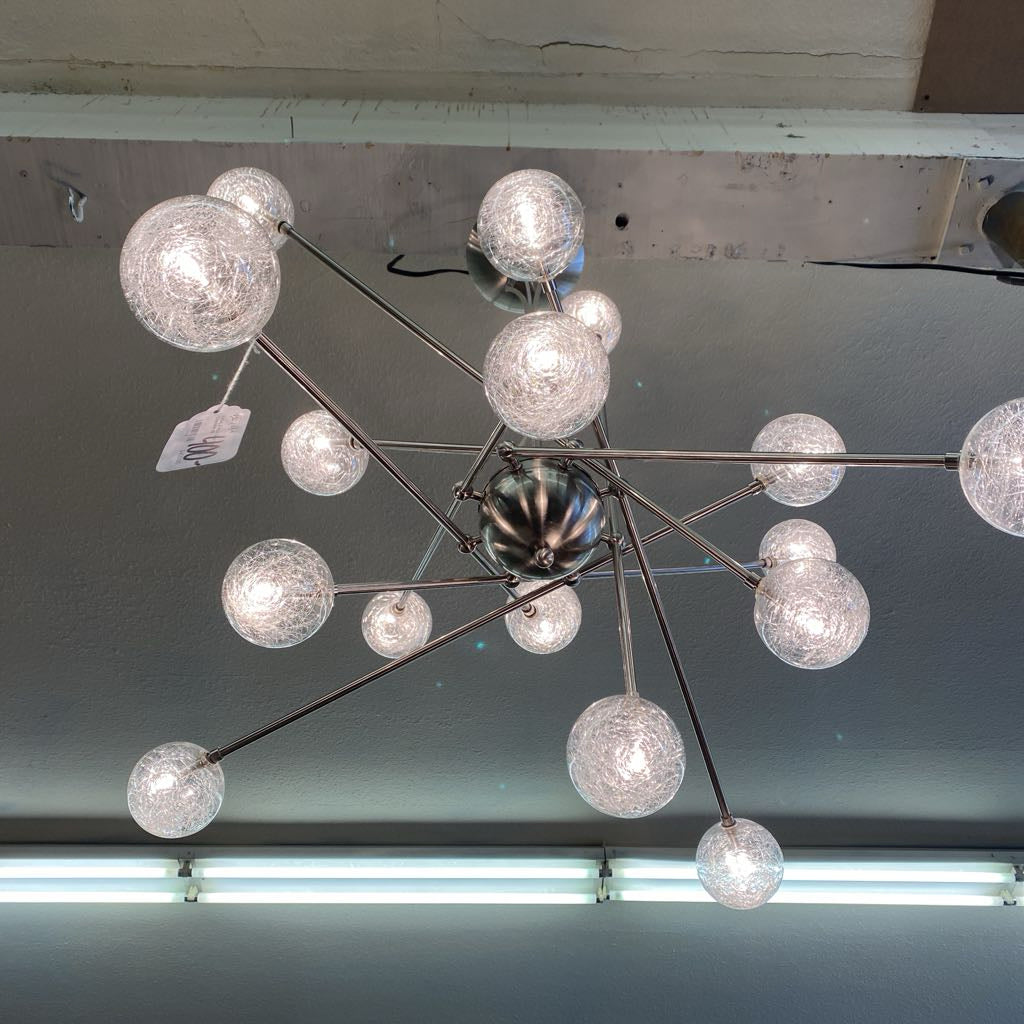 Modern chandelier with multiple glass globe lights on a ceiling.