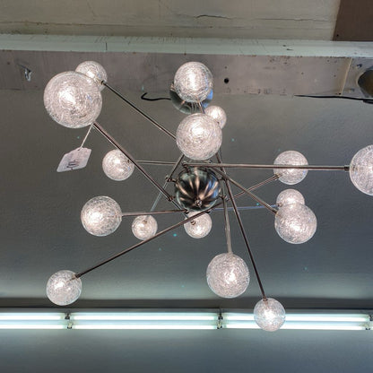 Modern chandelier with multiple glass globe lights on a ceiling.