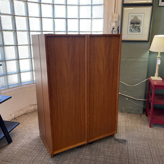 Wooden cabinet in a room with a window and lamp