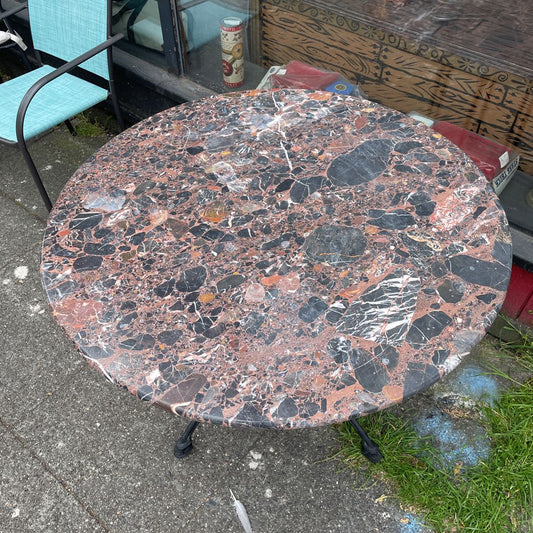 Close-up of a round marble-top bistro table