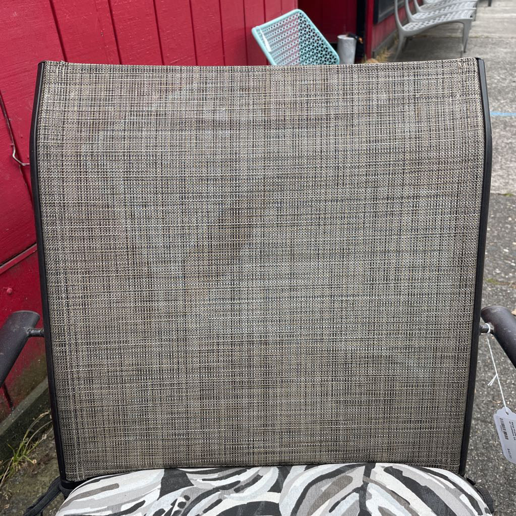Close-up of the grey mesh backrest of an outdoor patio chair