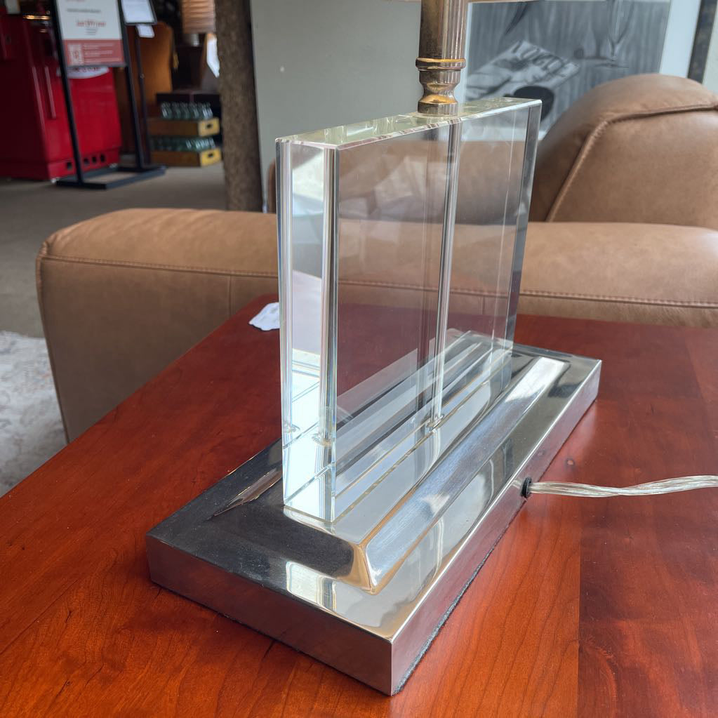 Close up of the clear acrylic and chrome base of a table lamp