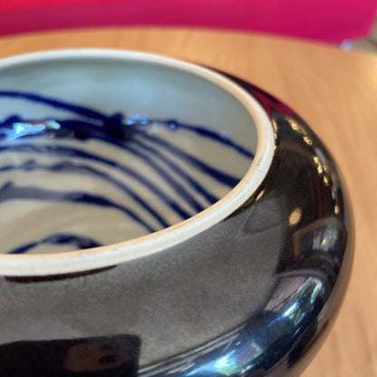 Black Vase with White and Blue Swirl Interior