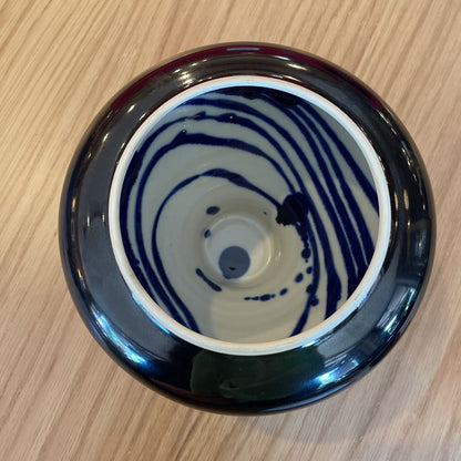 Black Vase with White and Blue Swirl Interior
