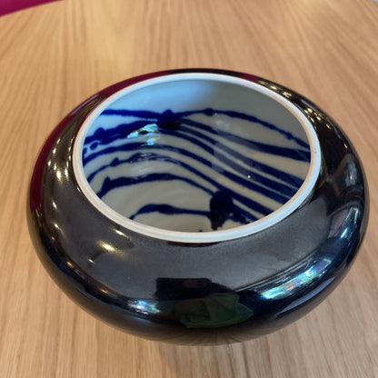 Black Vase with White and Blue Swirl Interior