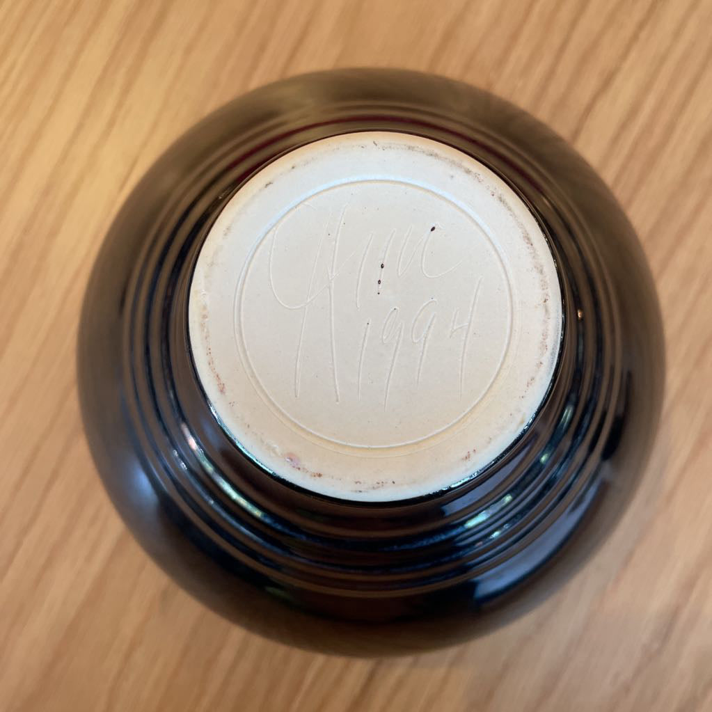 Black Vase with White and Blue Swirl Interior